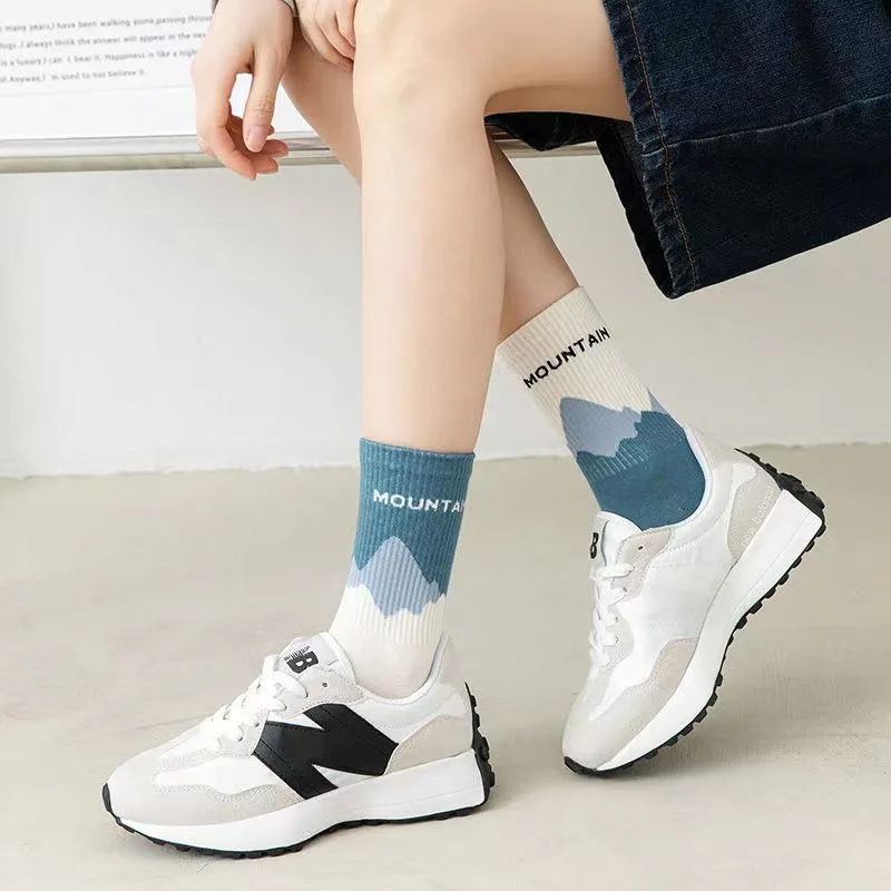 One mismatched pair of blue mountain socks. Shoes and clothing are not included.