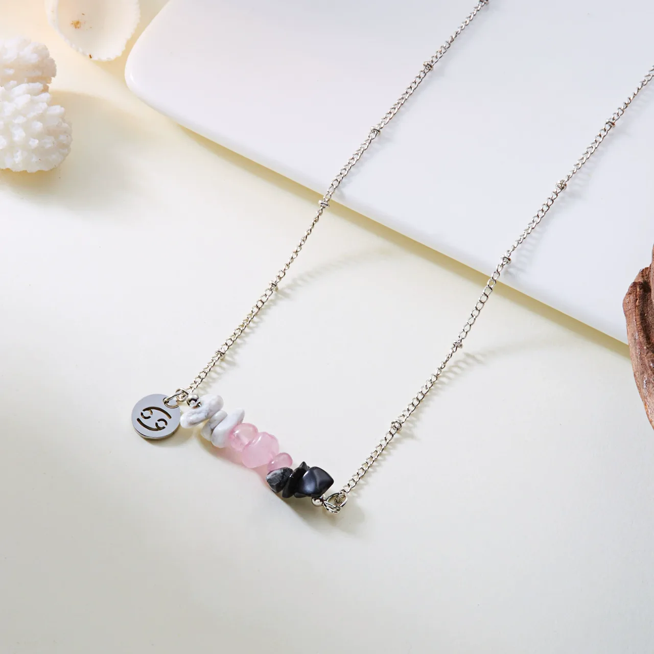 Close-up of the Cancer design, with white, pink and dark bead chips.
