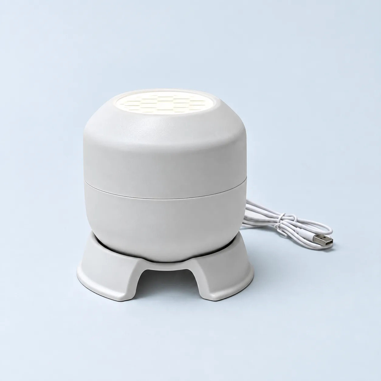 Snowflake projector with its base and USB-A lead. No wall adapter is included.