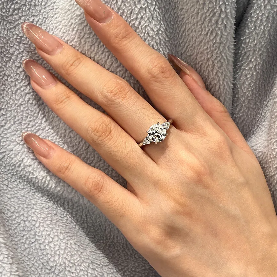 Supplier wearing example. Selected version: round 8 × 8 mm centre stone, adjustable open band.