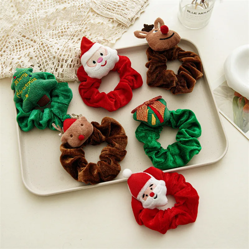 Collection styling image. Your choice is the brown scrunchie with the red-hatted reindeer; other designs are not included.