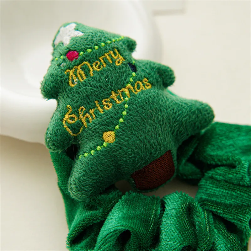 Close-up of the embroidered Christmas tree detail.